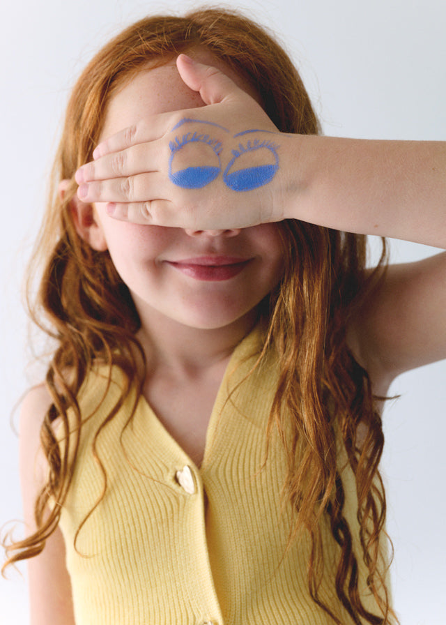 Yellow knitted vest with heart-shaped buttons