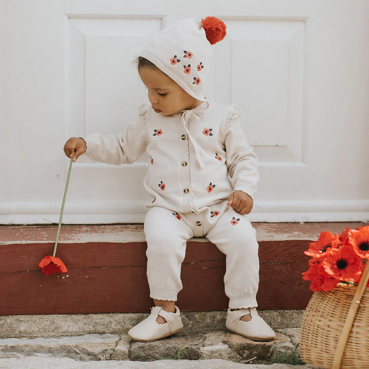 Combinaison en tricot beige à imprimé coquelicots