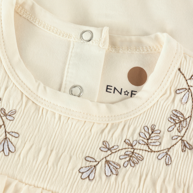 Embroidered onesie with smocked effect